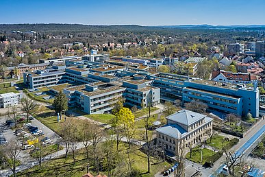 Luftaufnahme des langgesteckten und verzweigten Internistischen Zentrums in grüner Lage von Nordwest. Im Vordergrund die historische Sandsteinvilla der Kaufmännischen Direktion.